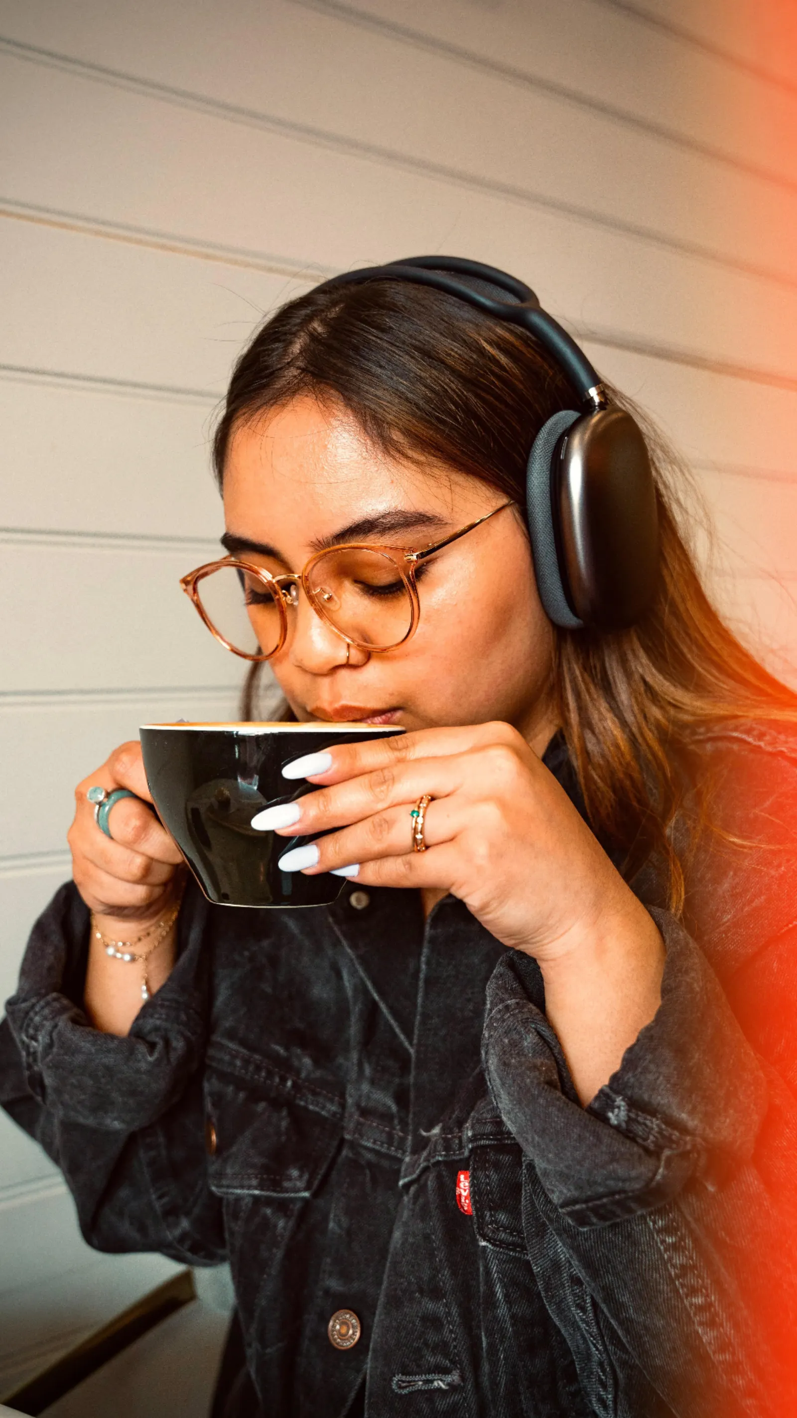 Creator wearing headphones with a coffee in a Cross X Agency lifestyle reel