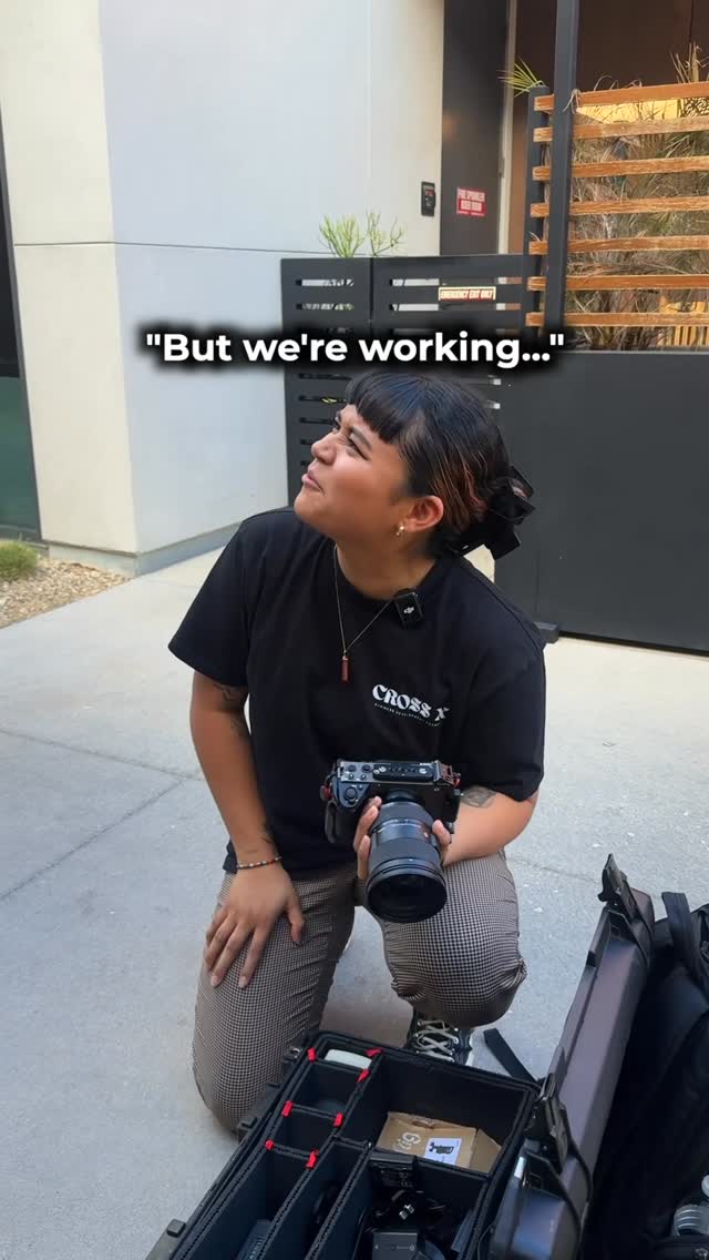 Cross X Agency videographer setting up camera gear behind the scenes of a shoot